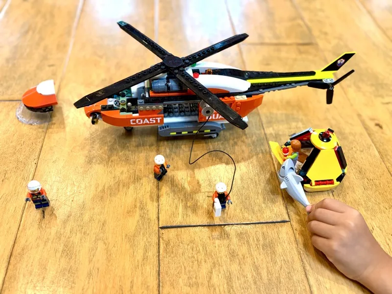 Jax playing with LEGO Coast Guard Helicopter rescue scene