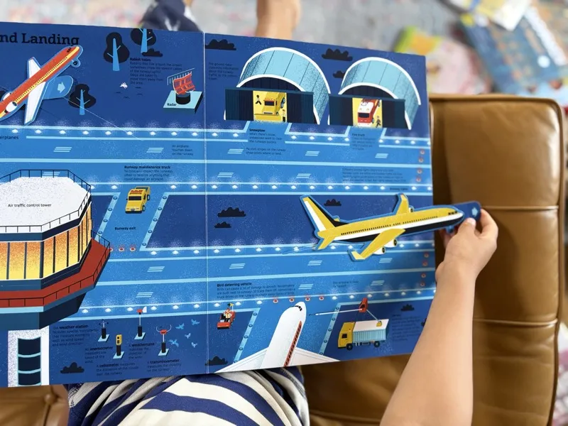 Jax reading The Ultimate Book of Airplanes and Airports