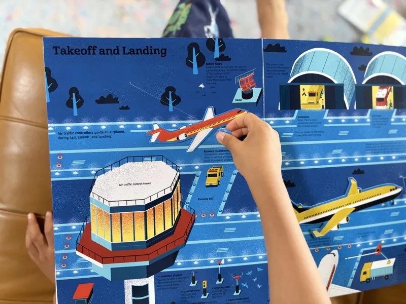 Jax reading The Ultimate Book of Airplanes and Airports